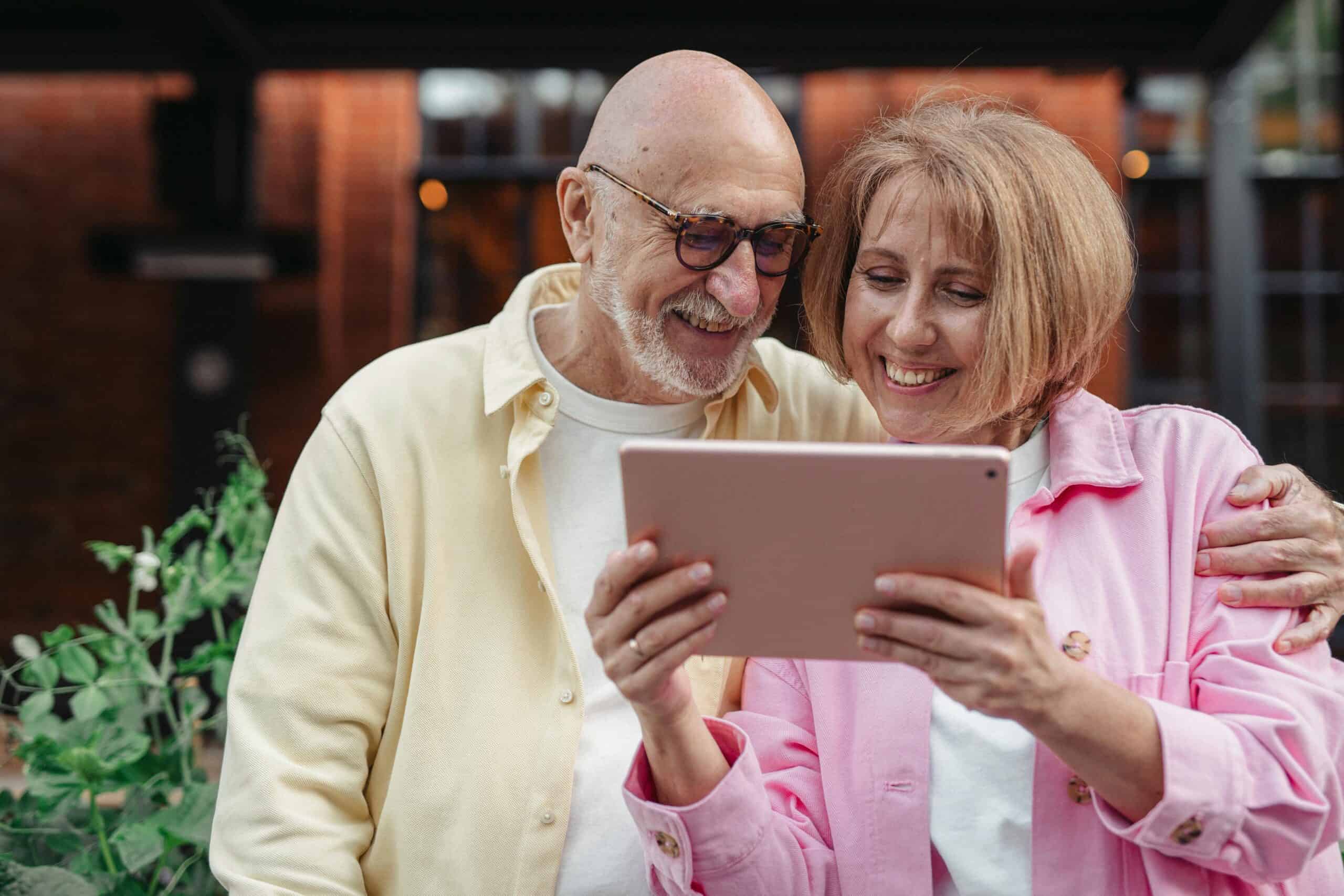 Senior couple choosing a community management company for their properties online