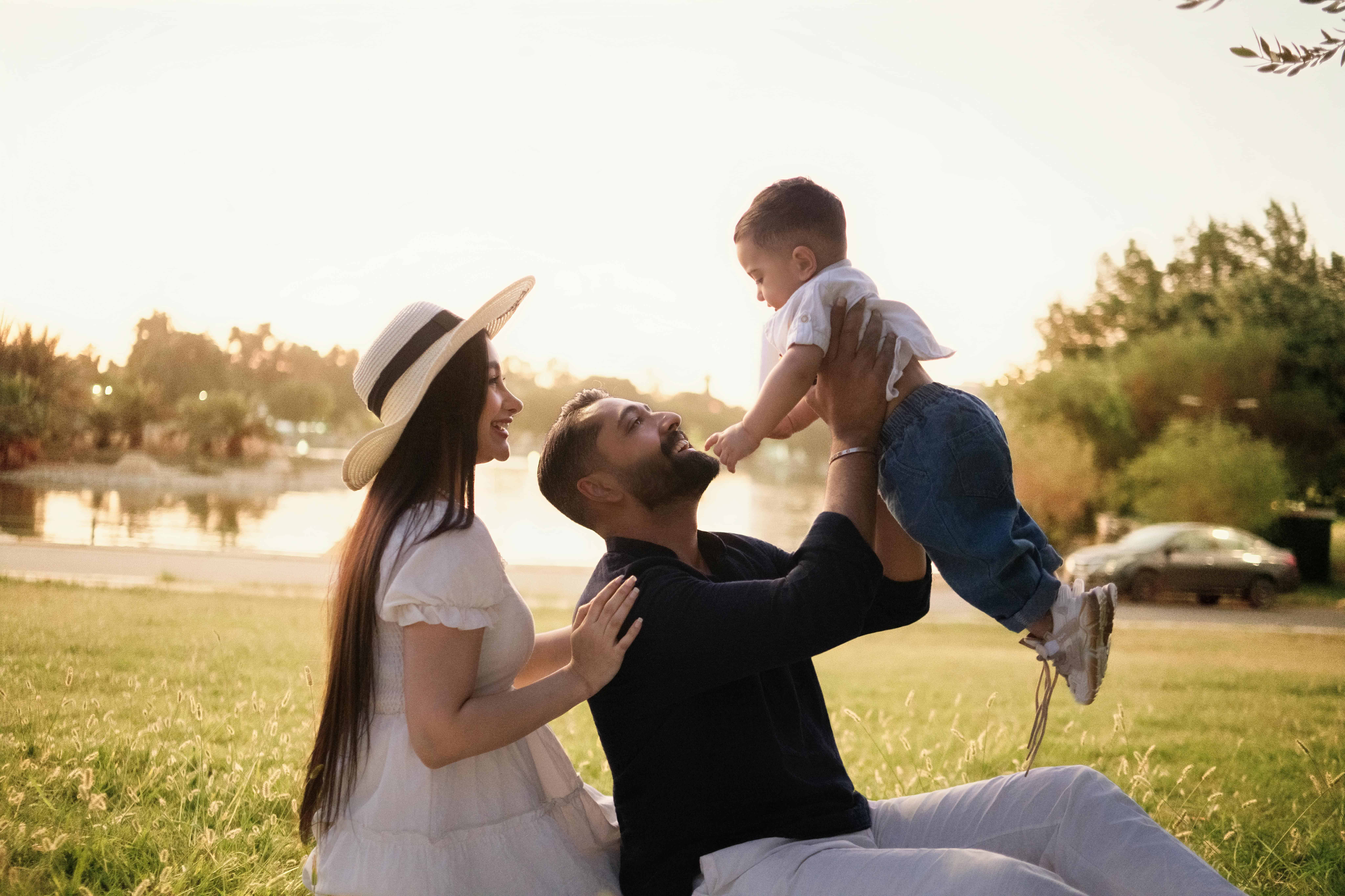 HOA Happy Day at Park Parents lifting their child during a sunny day at a park in the City of Fredericksburg VA.